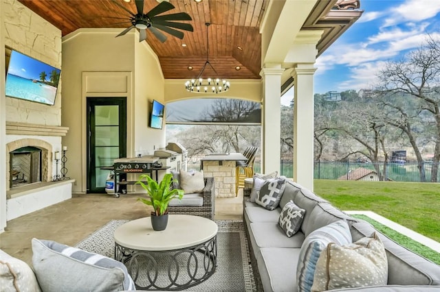 view of patio featuring ceiling fan and an outdoor living space with a fireplace