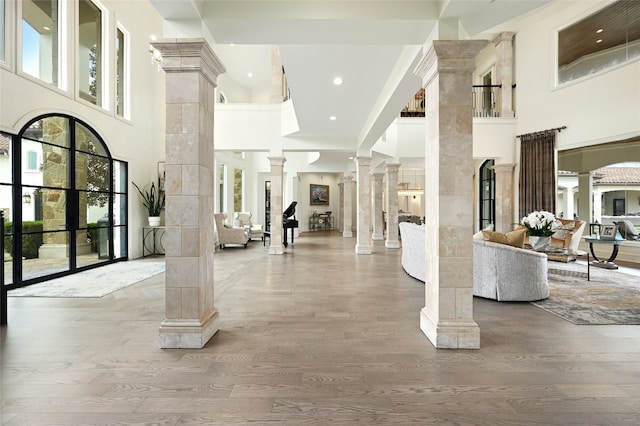 14132 Flat Top Ranch Rd, Austin, TX 78732 - entryway with decorative columns, a high ceiling, wood finished floors, healthy amount of natural light, and recessed lighting