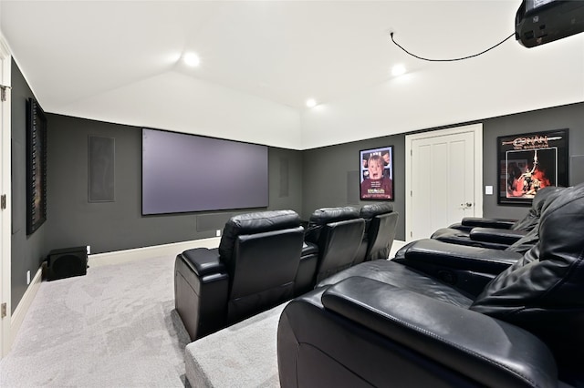 carpeted home theater room featuring vaulted ceiling