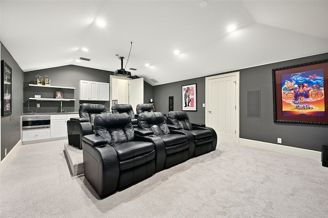 cinema featuring lofted ceiling and light carpet