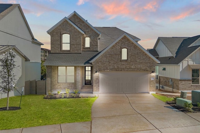 view of front of home featuring a garage and a yard