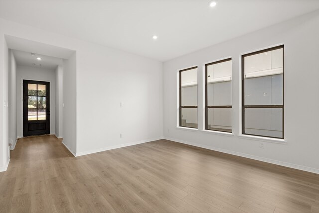 spare room featuring light hardwood / wood-style flooring