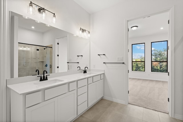 bathroom featuring tile patterned flooring, vanity, and walk in shower