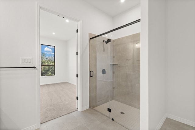 bathroom featuring tile patterned flooring and a shower with shower door