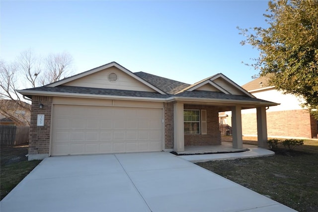 single story home with a garage and covered porch