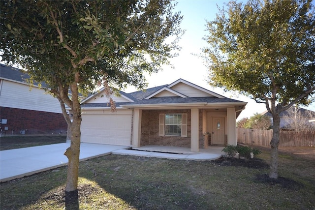 view of front of home with a garage, covered porch, and a front yard