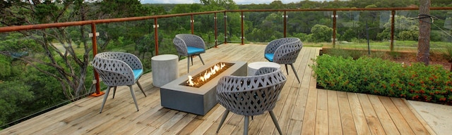 wooden terrace with an outdoor fire pit