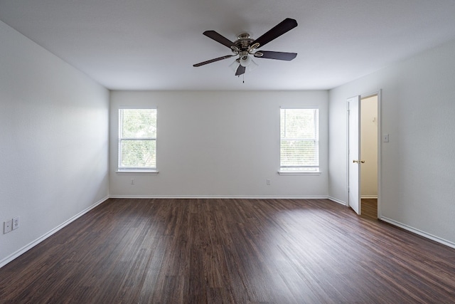 empty room with ceiling fan and dark hardwood / wood-style floors