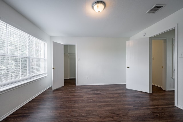 empty room featuring dark wood-type flooring