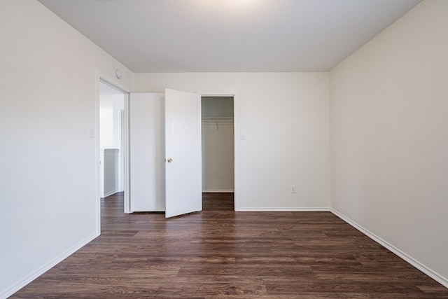 unfurnished bedroom with a closet and dark hardwood / wood-style flooring