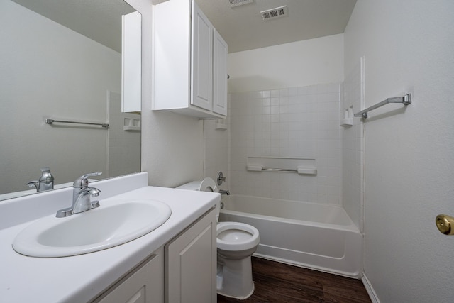 full bathroom with vanity, toilet, hardwood / wood-style flooring, and bathing tub / shower combination