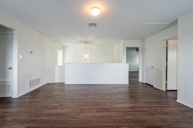 empty room with dark hardwood / wood-style floors and ceiling fan