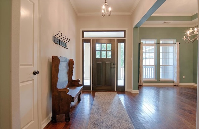 foyer with dark hardwood / wood-style floors, plenty of natural light, and a notable chandelier