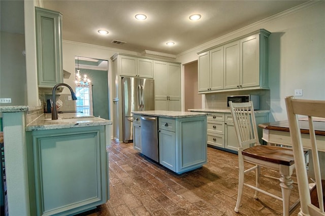 kitchen with appliances with stainless steel finishes, light stone counters, ornamental molding, sink, and dark hardwood / wood-style floors