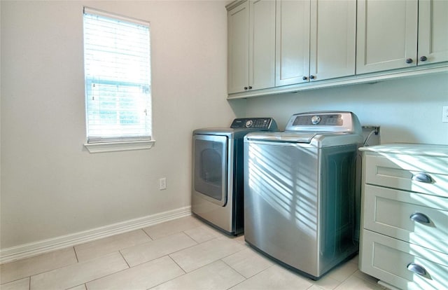 washroom featuring cabinets, separate washer and dryer, and light tile patterned flooring