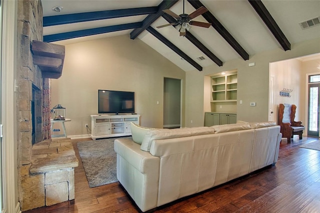 living room with ceiling fan, beamed ceiling, built in shelves, and dark hardwood / wood-style floors