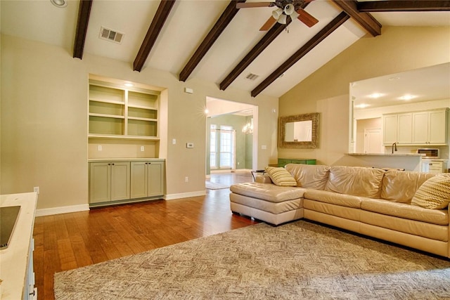 living room with high vaulted ceiling, hardwood / wood-style floors, beamed ceiling, and ceiling fan with notable chandelier