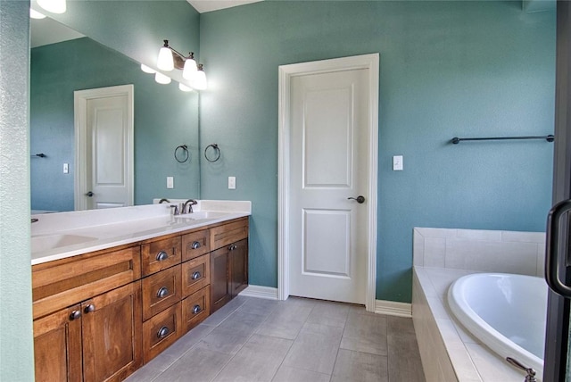 bathroom with vanity and tiled bath