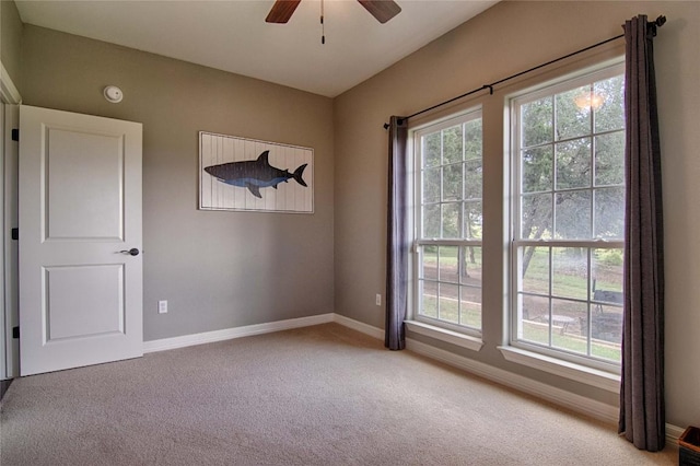 unfurnished room with light carpet and ceiling fan