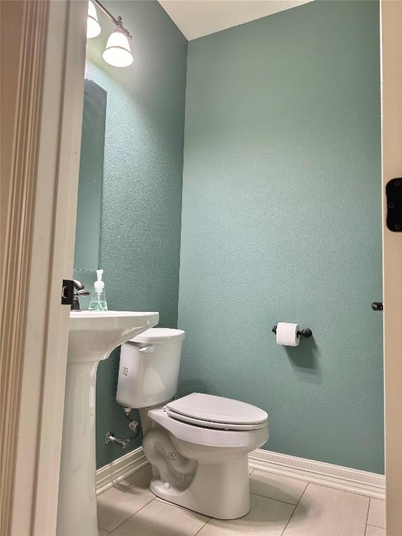 bathroom featuring tile patterned floors and toilet