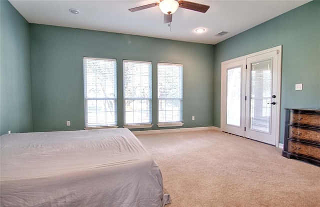 carpeted bedroom with ceiling fan and access to exterior