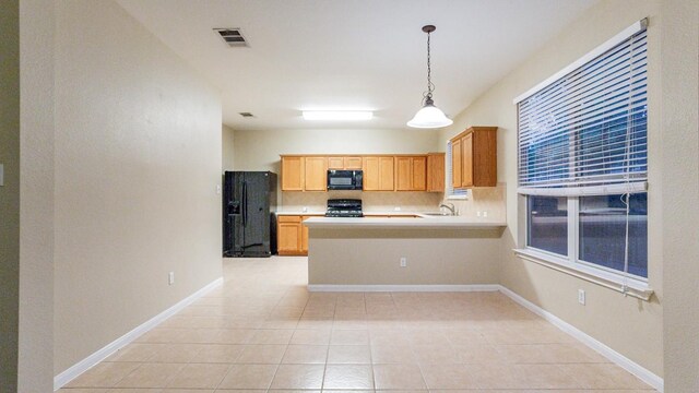 kitchen with light tile patterned flooring, backsplash, hanging light fixtures, kitchen peninsula, and black appliances