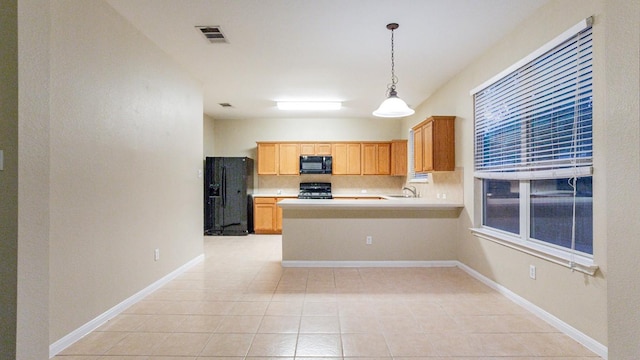 kitchen with visible vents, decorative backsplash, stove, light countertops, and black microwave