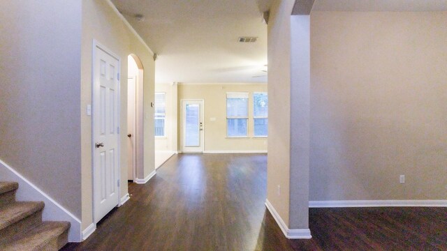 corridor with dark hardwood / wood-style flooring