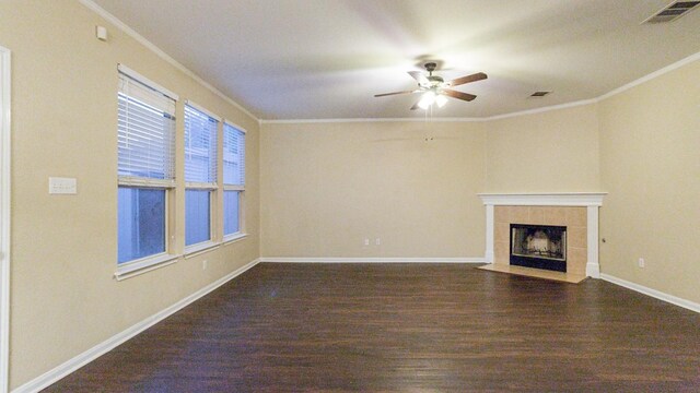 unfurnished living room featuring ceiling fan, a tiled fireplace, hardwood / wood-style floors, and ornamental molding