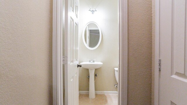 bathroom with tile patterned floors