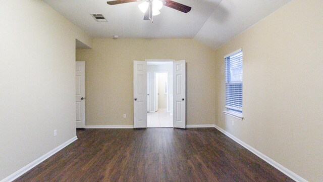 unfurnished bedroom featuring ceiling fan, vaulted ceiling, and hardwood / wood-style flooring