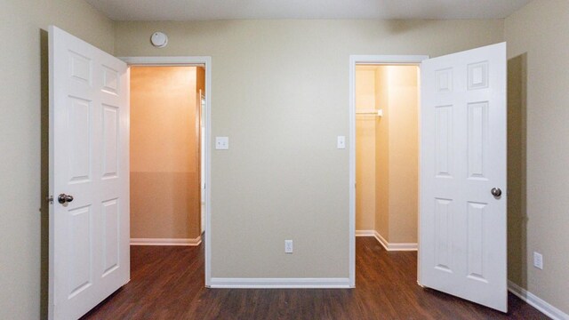 unfurnished bedroom with dark wood-type flooring