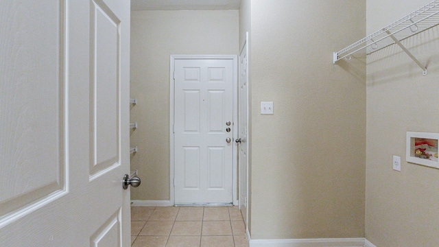 laundry area with hookup for a washing machine and light tile patterned flooring