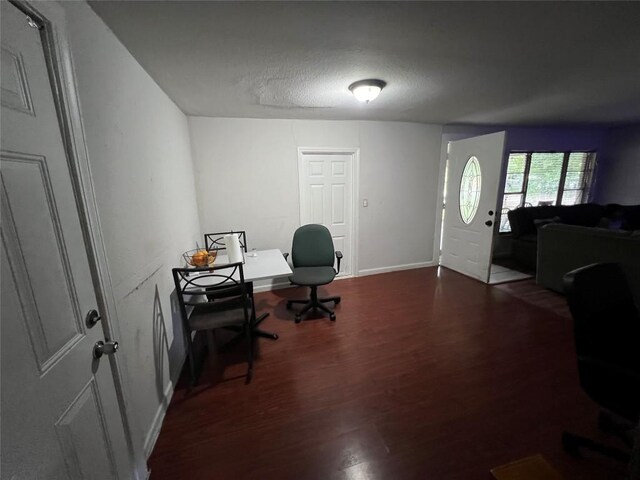 home office featuring wood-type flooring and a textured ceiling