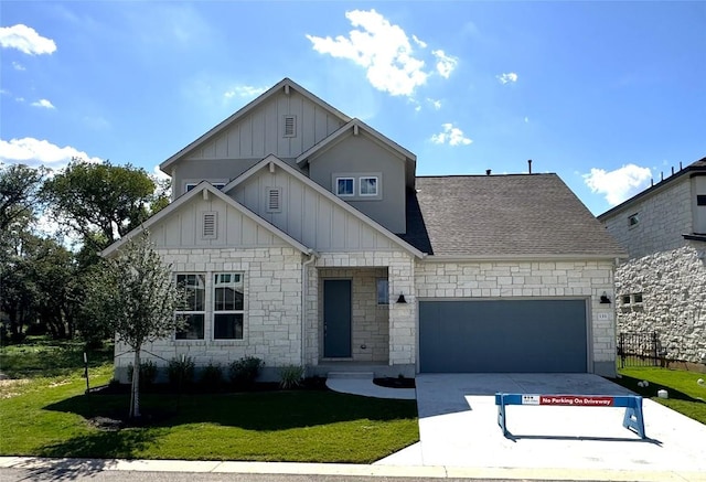 view of front of property with concrete driveway, roof with shingles, an attached garage, a front lawn, and board and batten siding