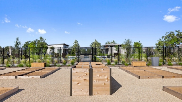 surrounding community with a vegetable garden and fence