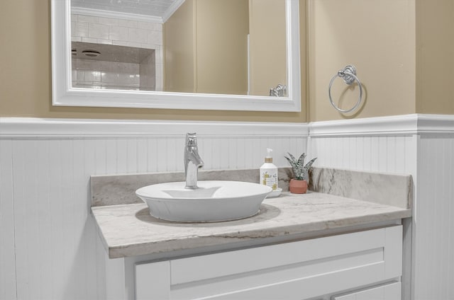 bathroom with vanity and ornamental molding