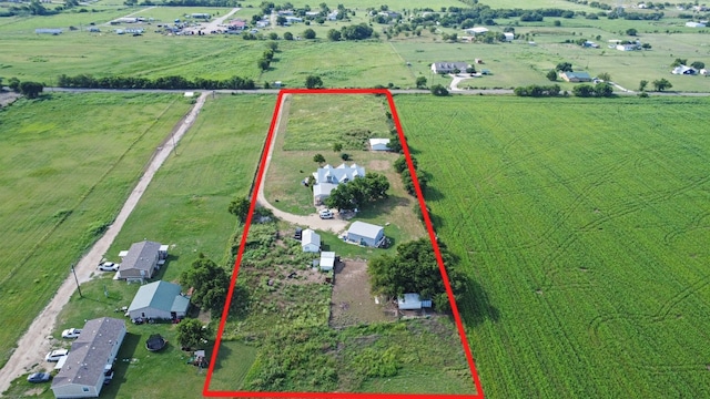 birds eye view of property with a rural view