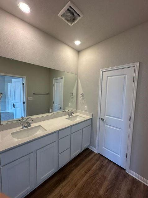 bathroom featuring hardwood / wood-style flooring and double sink vanity