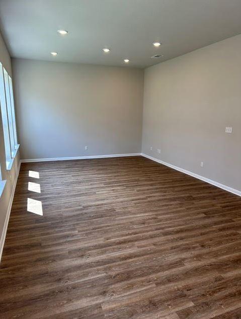 empty room with dark hardwood / wood-style flooring