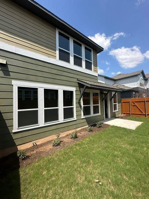 back of house with a lawn