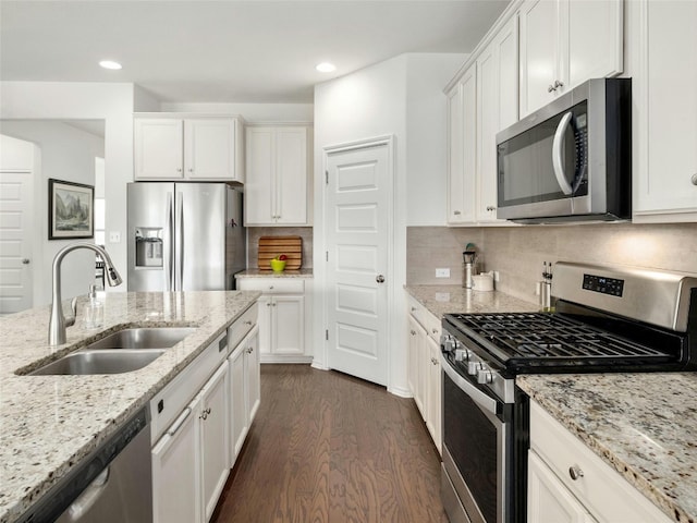 kitchen featuring white cabinets, decorative backsplash, sink, dark hardwood / wood-style floors, and appliances with stainless steel finishes