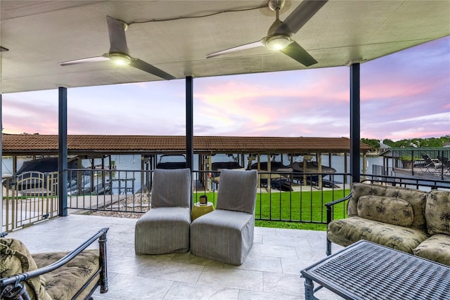 patio terrace at dusk featuring ceiling fan