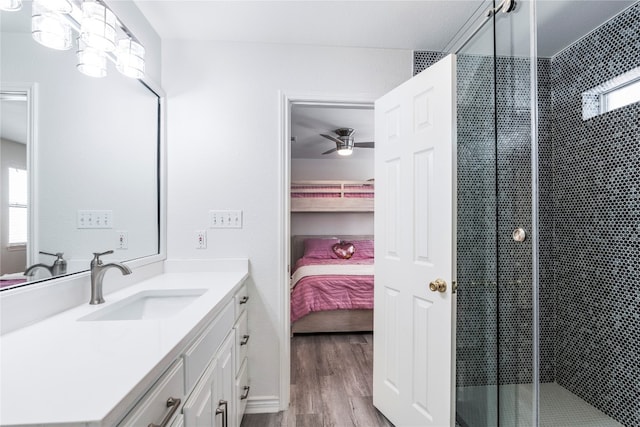 bathroom with wood-type flooring, an enclosed shower, and vanity