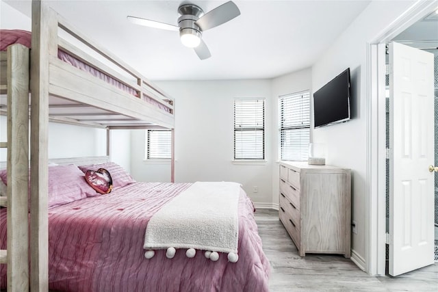 bedroom featuring baseboards, a ceiling fan, and light wood-style floors