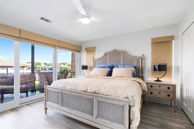 bedroom with hardwood / wood-style flooring, ceiling fan, and access to exterior