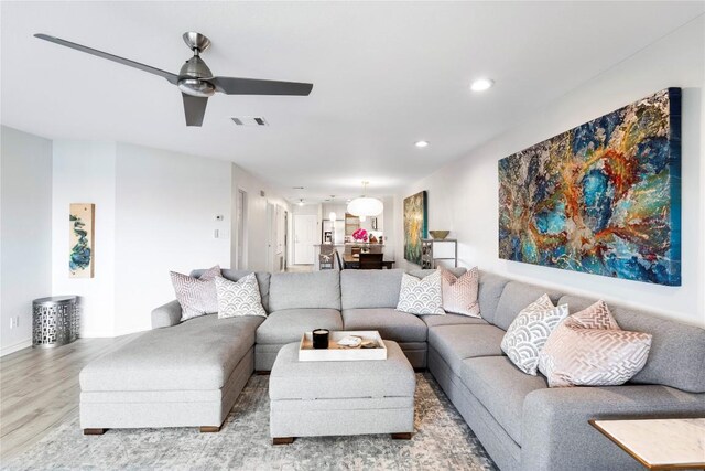 living room with recessed lighting, visible vents, wood finished floors, and ceiling fan