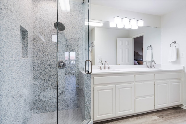 bathroom with vanity, wood-type flooring, and walk in shower