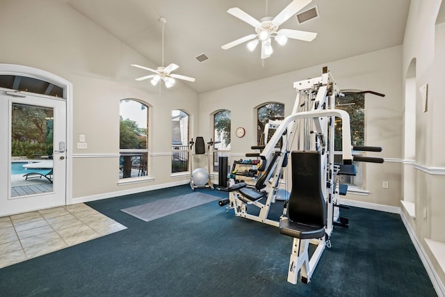 workout area featuring ceiling fan, tile patterned flooring, and high vaulted ceiling