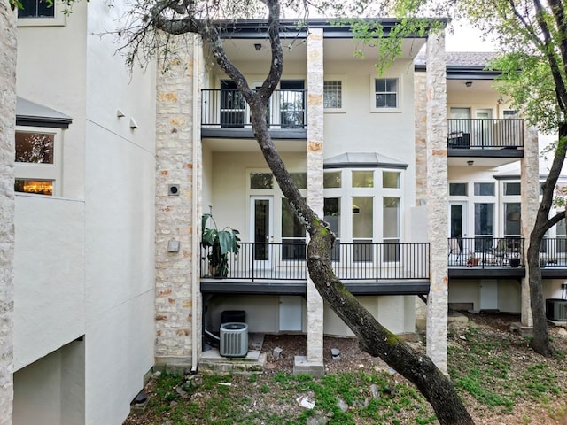 rear view of house featuring central air condition unit